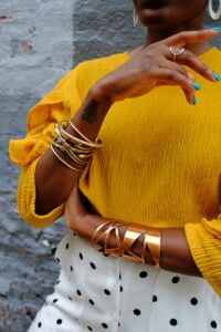 woman in yellow sweater wearing gold bracelet Bangkok The Mecca of Gemstones and Fine Jewellery Making