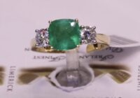 F1 40170G5 | E1.61/D0.61 | Cushion Emerald with Two Side Diamonds | Set in 18ct Yellow Gold