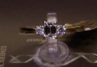 #65789 | T0.52ct | Emerald Cut with Two Round Brilliant Side Diamonds | Set in 18ct Yellow Gold